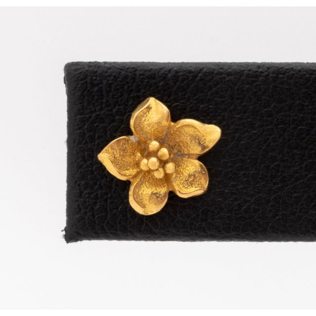 22K Yellow Gold Floriform Stud Earrings, designed as blossom flowers, worn through pierced earlobes with threaded posts...