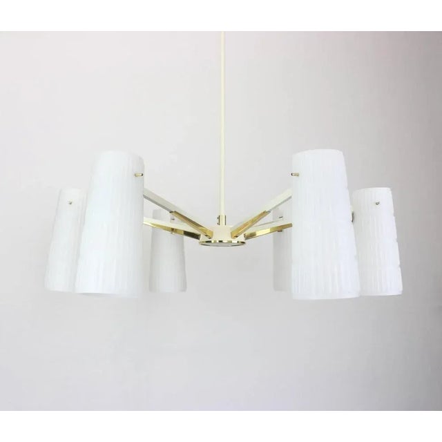 A stunning six-light chandelier in the manner of stilnovo, italy, manufactured in circa 1950-1959. A handmade and high...