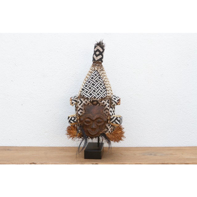 This captivating African Beaded Lele Tribe Mask, hailing from the Democratic Republic of Congo, is a testament to the rich...