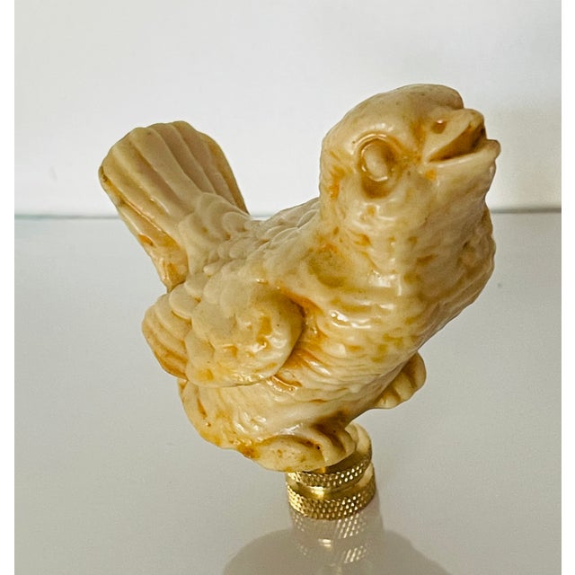 Lovely casted singing sparrow bird figurine mounted on a brass base as lamp finial.
