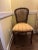 Charming pair of antique French Louis XV–style caned side chairs, featuring hand-carved walnut frames with delicate floral...