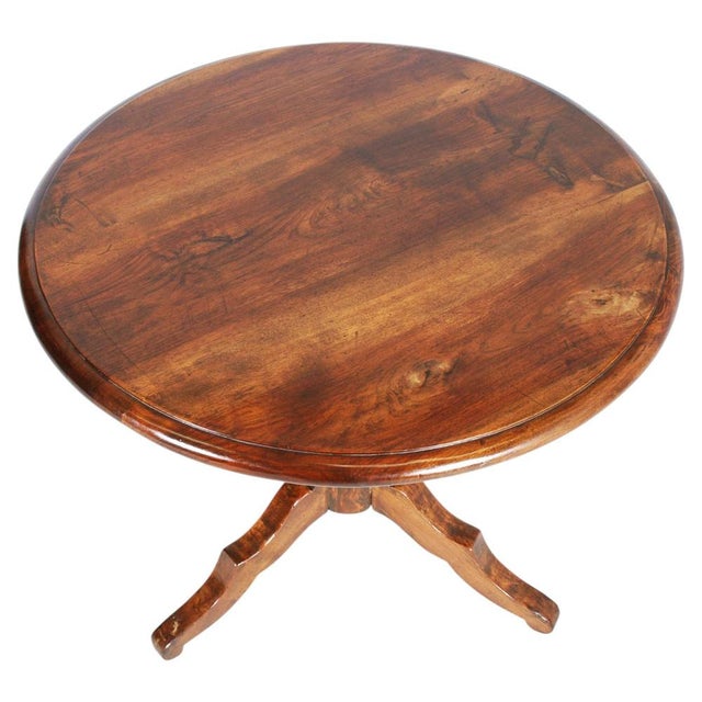 An elegant and timeless 19th-century Italian walnut tripod table, defined by its harmonious proportions and refined...