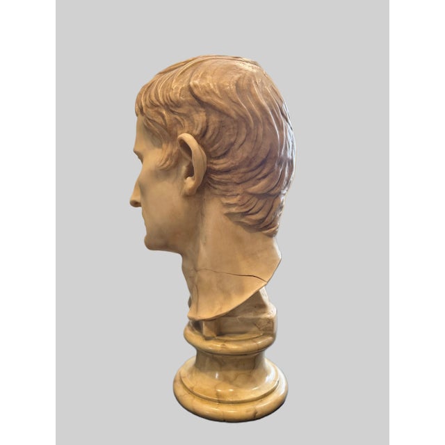 A striking Neoclassical-style bust inspired by classical Roman portraiture, featuring refined facial features and detailed...