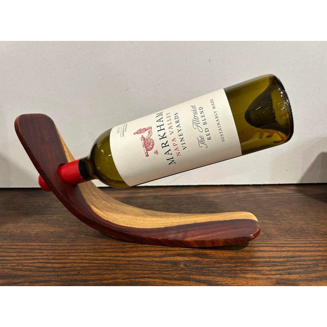 Handmade African Blackwood gravity/floating wine bottle holder. Designed to keep the wine cork from drying out. This...