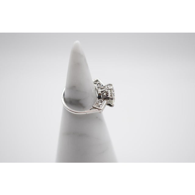 This is a stunning solitaire diamond ring set in platinum. The main stone is a 3.80 carat old European cut diamond with...