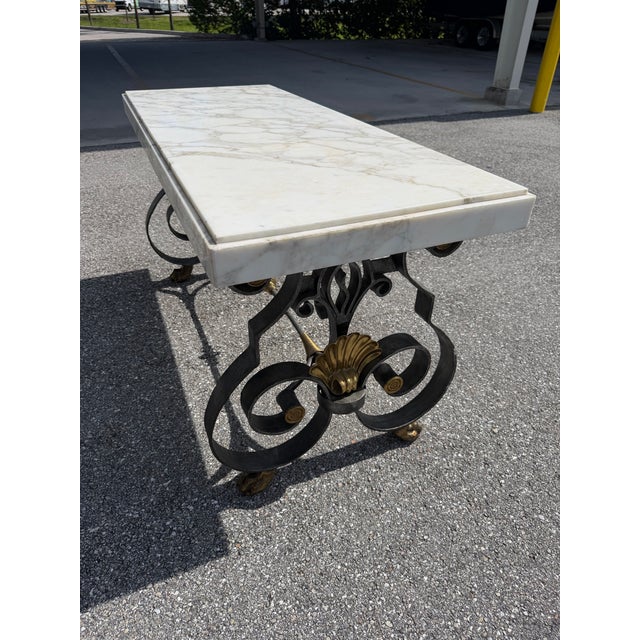 Topped by a 2.5 inch thick white marble with subtle gray veining, this type of table with a highly scrolled cast iron base...