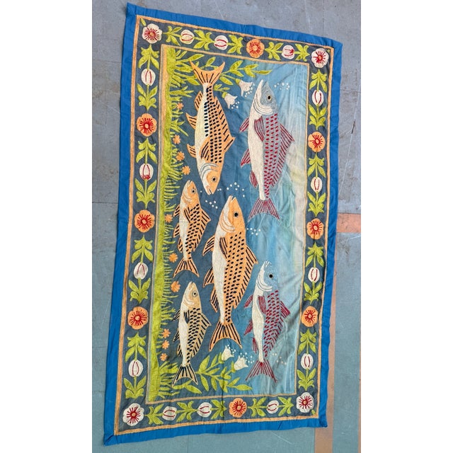 This vintage embroidered cotton textile wall hanging with fish motif captures the soul of traditional craftsmanship,...