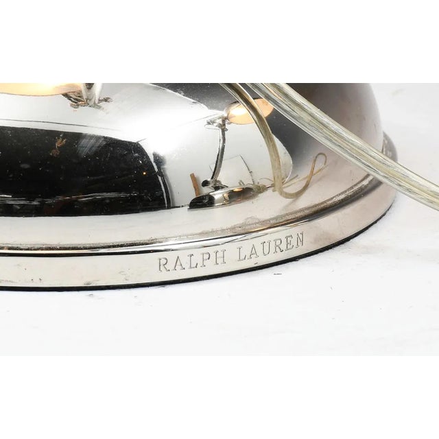 A striking pair of polished chrome articulated desk lamps by Ralph Lauren Home, embodying the brand’s signature blend of...