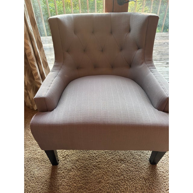 Purchased in 2017, these gray Royersford arm chairs are being sold as a pair. They feature button-tufted backs, sloped...