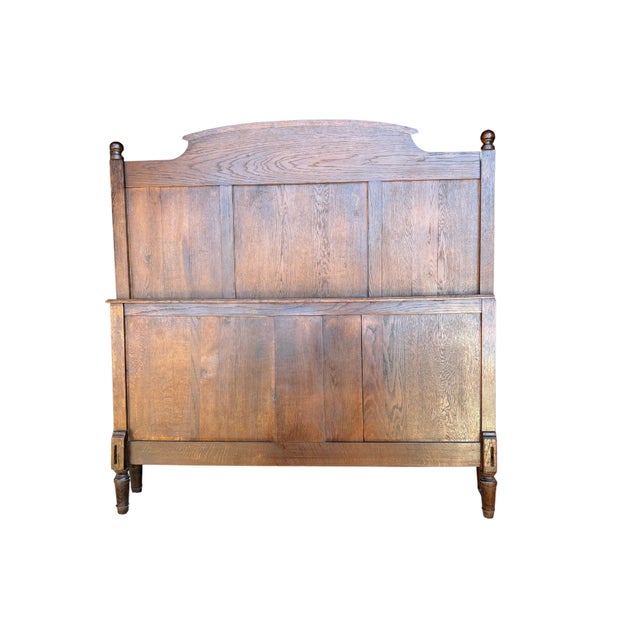 The headboard showcases a beautiful carved floral basket motif centered within an arched top, adding a touch of...