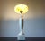This extraordinary table lamp with a marble foot in the shape of a narrow amphora, standing on a square base and a marble...