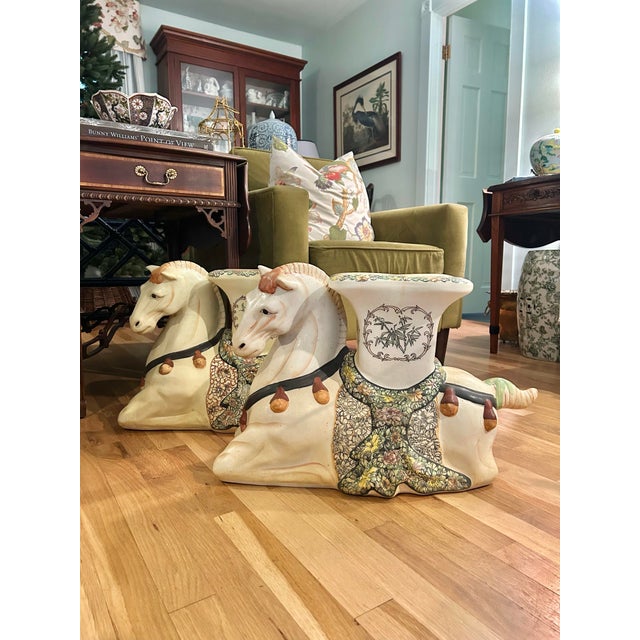 We consider this pair of ceramic garden stools a rare find. The elephant stools are here and there, and we see camels… but...