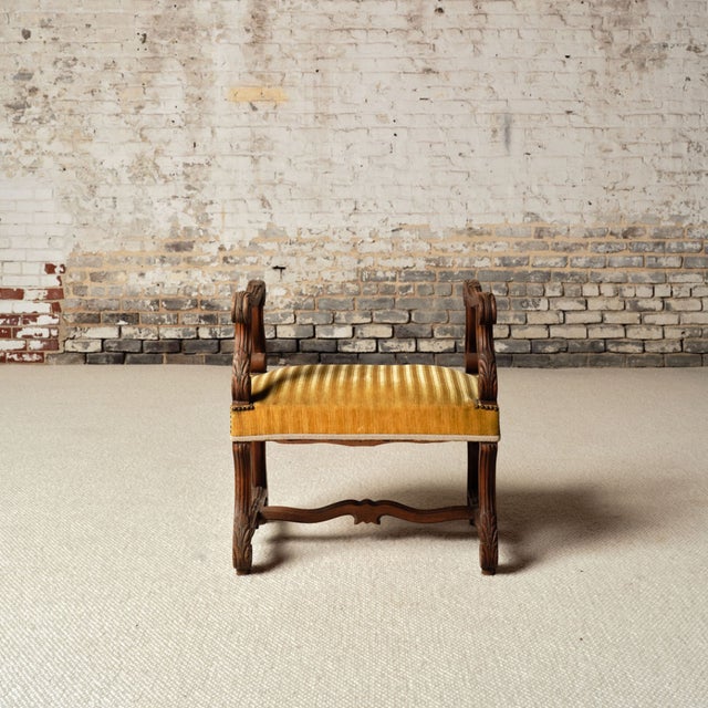 Add classic French charm and functional elegance to your space with this early 20th century French wood and upholstered...