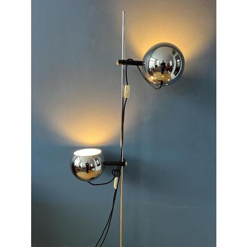 A classic eyeball floor lamp in chrome by Herda. The shades can be turned in any direction desirable and move up and down...