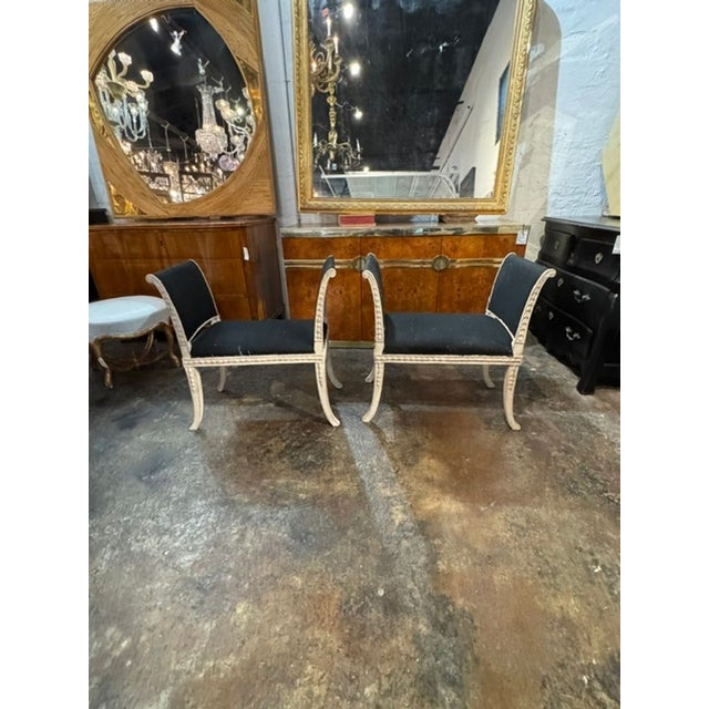 The product is a pair of vintage Swedish carved and painted benches that add a touch of charm to any space. The intricate...
