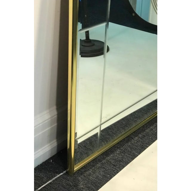 Pair of brass mirrors in die etched style, 1980’s. Made in the USA. In good condition. Each measure 48” high by 36” wide,...