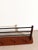 Elegant mid-century modern wall coat rack featuring a warm teak wooden base combined with sleek black metal bars and...
