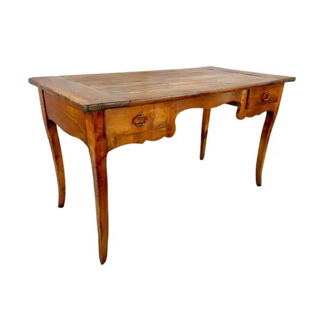 19th Century Louis XV Style French Provincial Desk. Desk features an aged patina with warm, rich tones. Desk is designed...