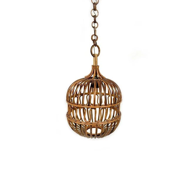 Midcentury ceiling lantern in rattan and bamboo. Made in Italy in the 1960s. This suspension lamp is entirely handcrafted...