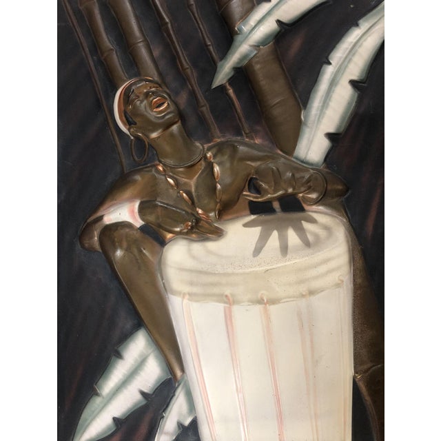 Vintage Cooper Embossed Bongo Player Wood Framed by C.I.E. Pearson. This vintage copper embossed piece of art depicts a...