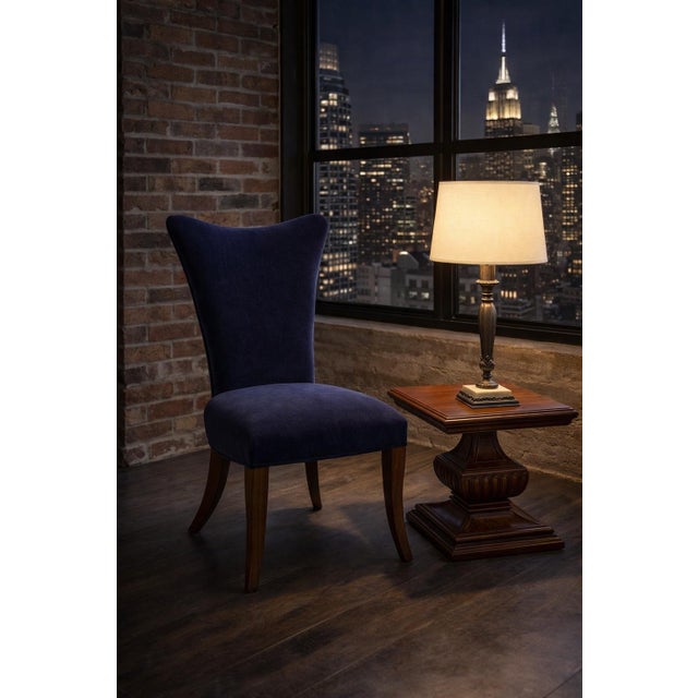 Sculptural navy velvet accent chair with a dramatic curved wing back and cabriole legs in an Old Chapel Satin Walnut...