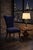 Sculptural navy velvet accent chair with a dramatic curved wing back and cabriole legs in an Old Chapel Satin Walnut...