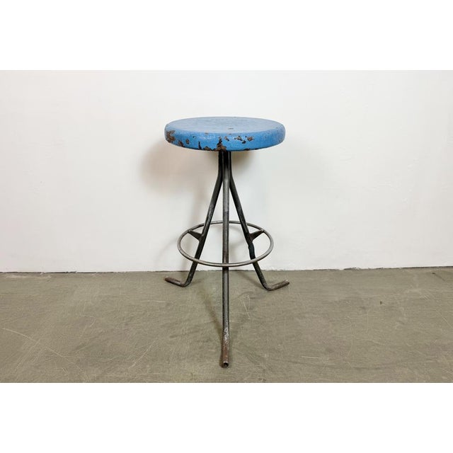 Vintage Industrial factory stool made in former Czechoslovakia during the 1960s It features a blue painted wooden seat and...
