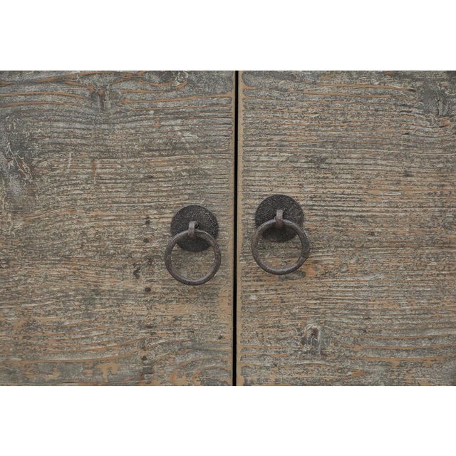 Antique Chinese Painted Elm Buffet Cabinet, in its original faded black lacquer finish, 2 large doors with iron door rings...