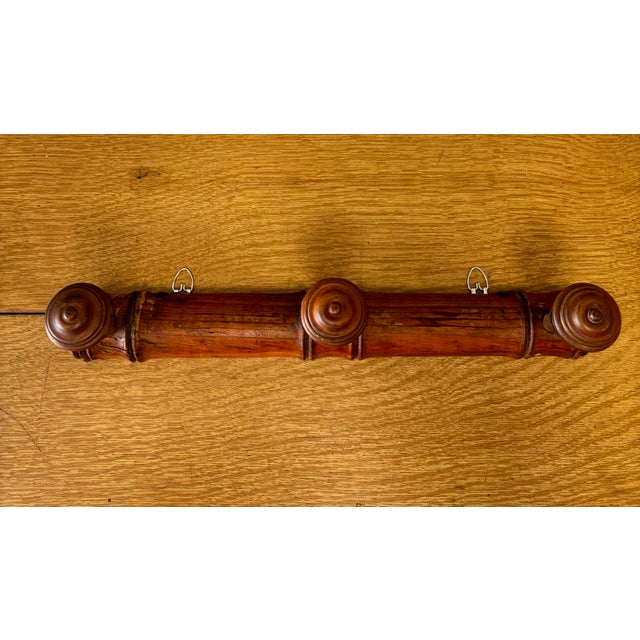 A charming vintage French wooden coat rack crafted in the classic faux bamboo style, a design long favored for its...