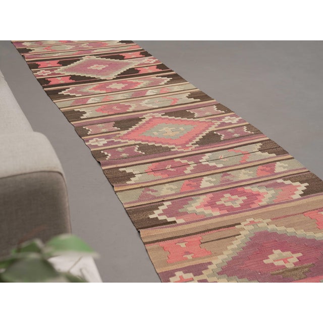 Vintage Hand-Knotted runner rug is a semi-antique vintage runner rug. The '70s Eastern region of Anatolia's unique rug is...