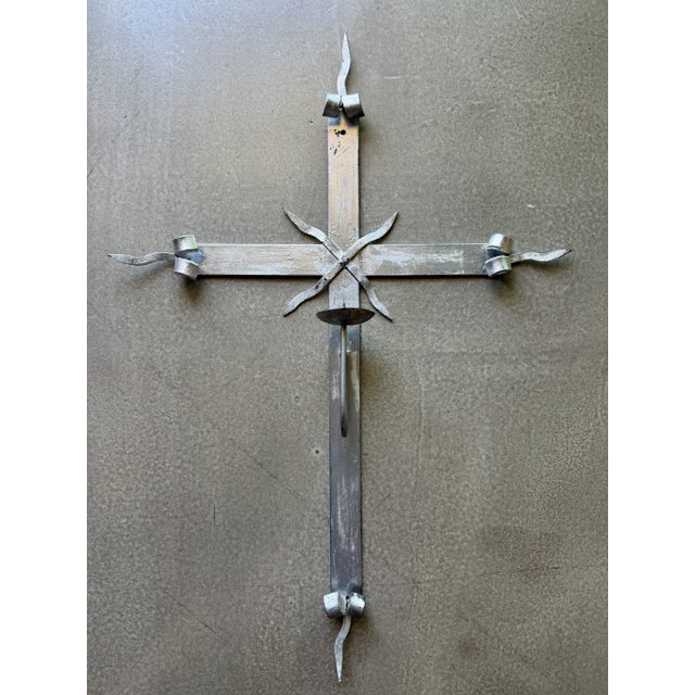 This hand-forged wrought iron wall sconce dates to the late 20th century and reflects the traditional metalworking...