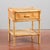 This small bamboo and wicker nightstand is a charming example of modernist and vintage design, particularly popular...