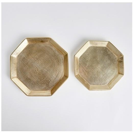 The Gold Octagonal Serving Tray Set - Set of 2 Dimensions: Large 11.5 x 10.75 x 1 - Small 9.75 x 9 x 1 A geometric shape...