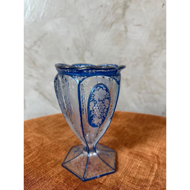 Art Deco vase in blue and clear Bohemian crystal, dating from the 1920s. This elegant piece features a slender shape...