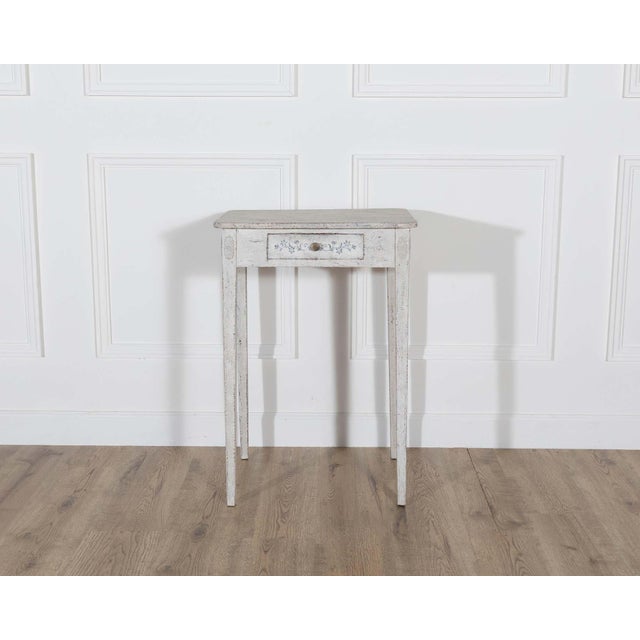 A beautifully painted Swedish console table dating from around 1880, showcasing the delicate charm and balance of late...
