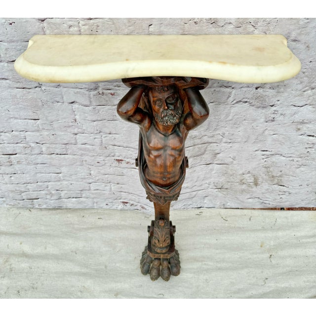 Distinctive 19th century figural carved walnut figure of a man holding a marble top. Bearded figure has his arms raised...