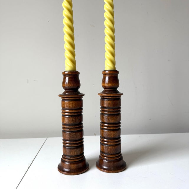 Vintage pair of dark oak spindle candlestick holders.