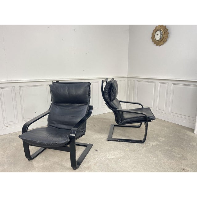 Pair of Ikea black leather armchairs dating from the 1980s. Comfortable and elegant with their timeless vintage design,...