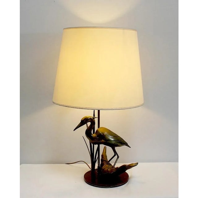 Elegant Table Lamp Brass 1970, representing a Heron surrounded by reeds and resting on a branch. Symbol of Peace, the...
