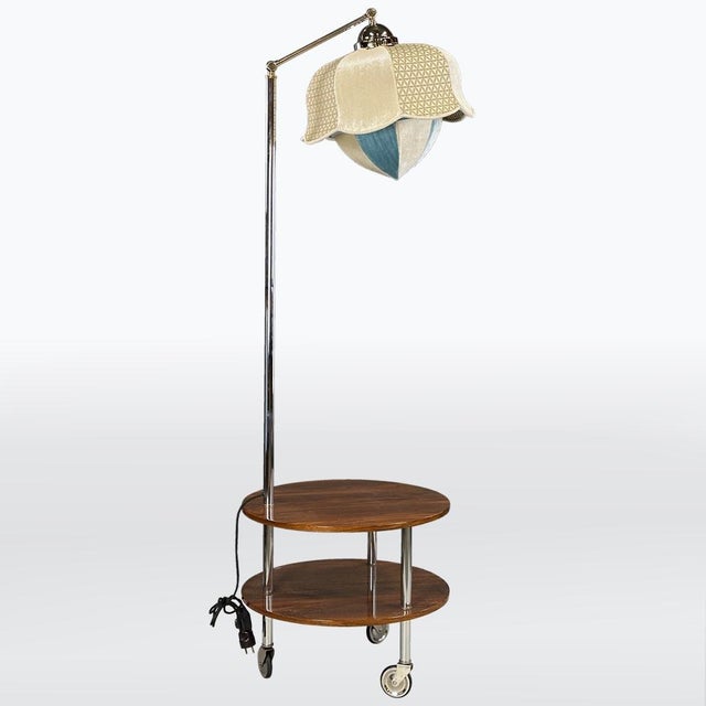 A functional and visually striking floor lamp from the late 1930s to early 1940s. The chrome-plated metal structure...