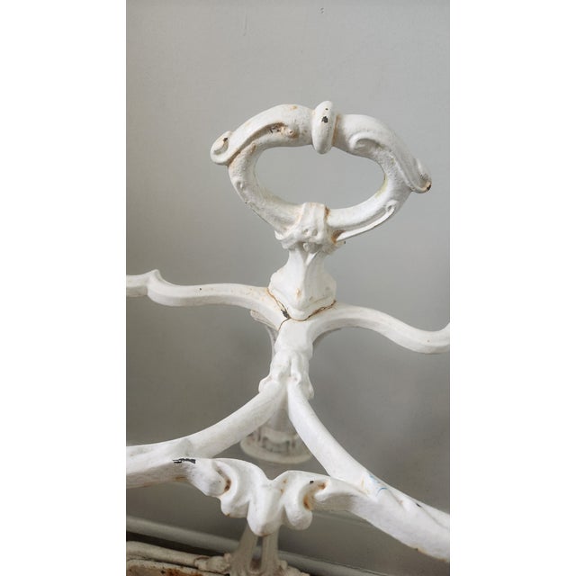 An antique Victorian cast iron umbrella stand featuring ornate decorative casting, ring holders, and an integrated drip...