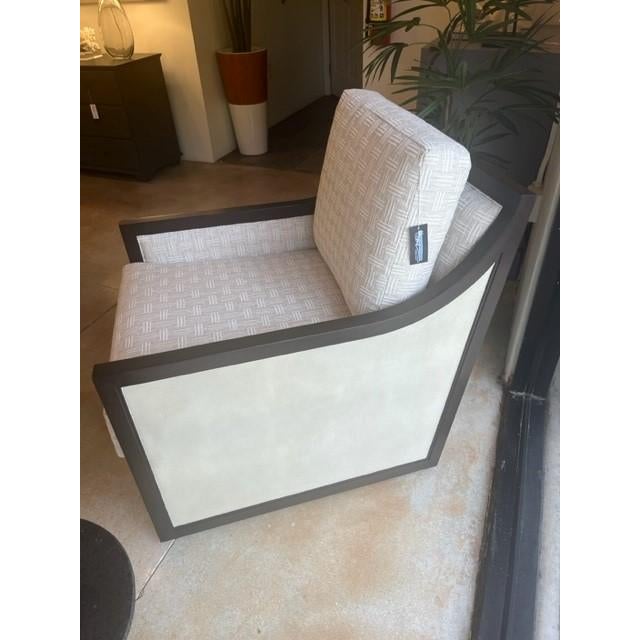 The Evie Walnut Swivel Armchair is made of mahogany in a dark walnut finish. The wood-framed front, side, and back panels...