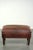 This vintage ottoman is made of sheepskin in a brown color scheme with a timeless look. The ottoman shows some signs of...