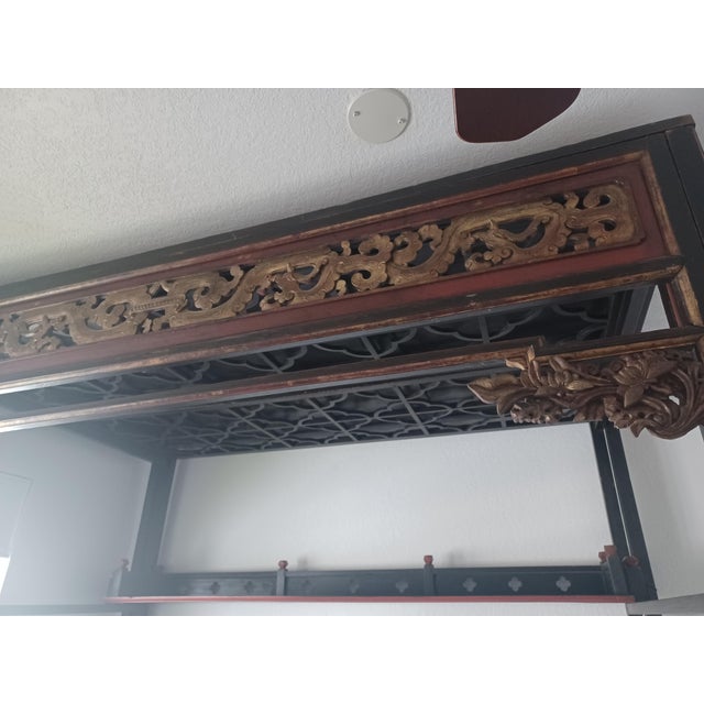 Circa 18th century hand carved.chinese wedding bed with canopy. Stained Black with red and gold flower motifs. Lattice...