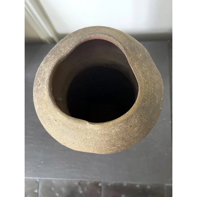 A stoneware vase by Paul Chaleff (1947-) made in 1984. Chaleff is known for his wood fired ceramic vessel without glaze or...