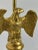 A Federal style eagle table lamp produced in the United States during the 1950s, combining gilt metal, brass, and turned...