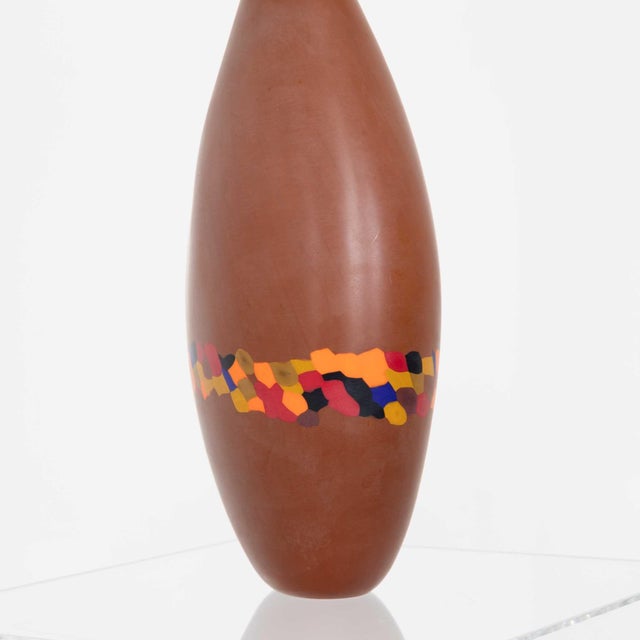 Decorative murine Murano art glass vase. Cased glass in brown with wrap around multi colored band . Signed underneath.