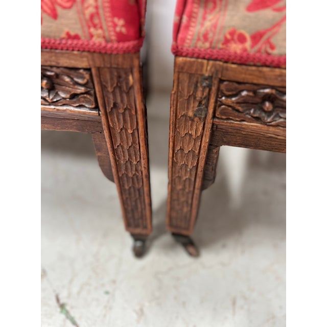 Pair of Gothic-style lounge chairs Carved solid walnut frames Good condition Dimensions: H 102 x W 50 x D 40 cm 19th century