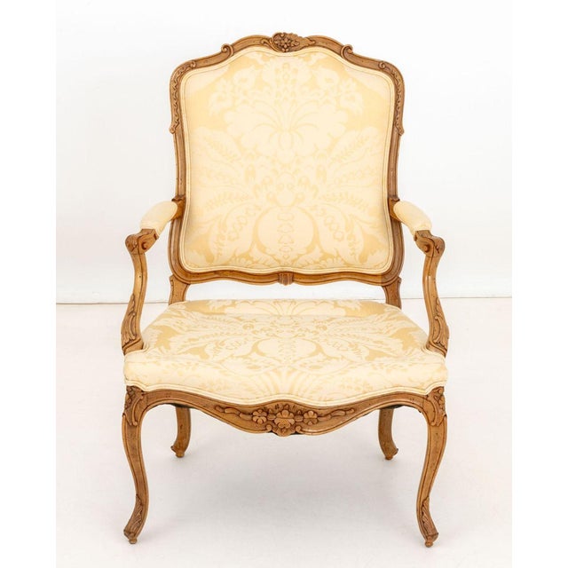 Louis XV Style Cream Wool Damask Upholstered Walnut Fauteuil, the legs carved with acanthus leaf motif. 38" H x 27" W x...