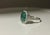 A show-stopping 18K white gold cocktail ring centered on a magnificent 10.20 carat natural oval emerald, surrounded by 66...